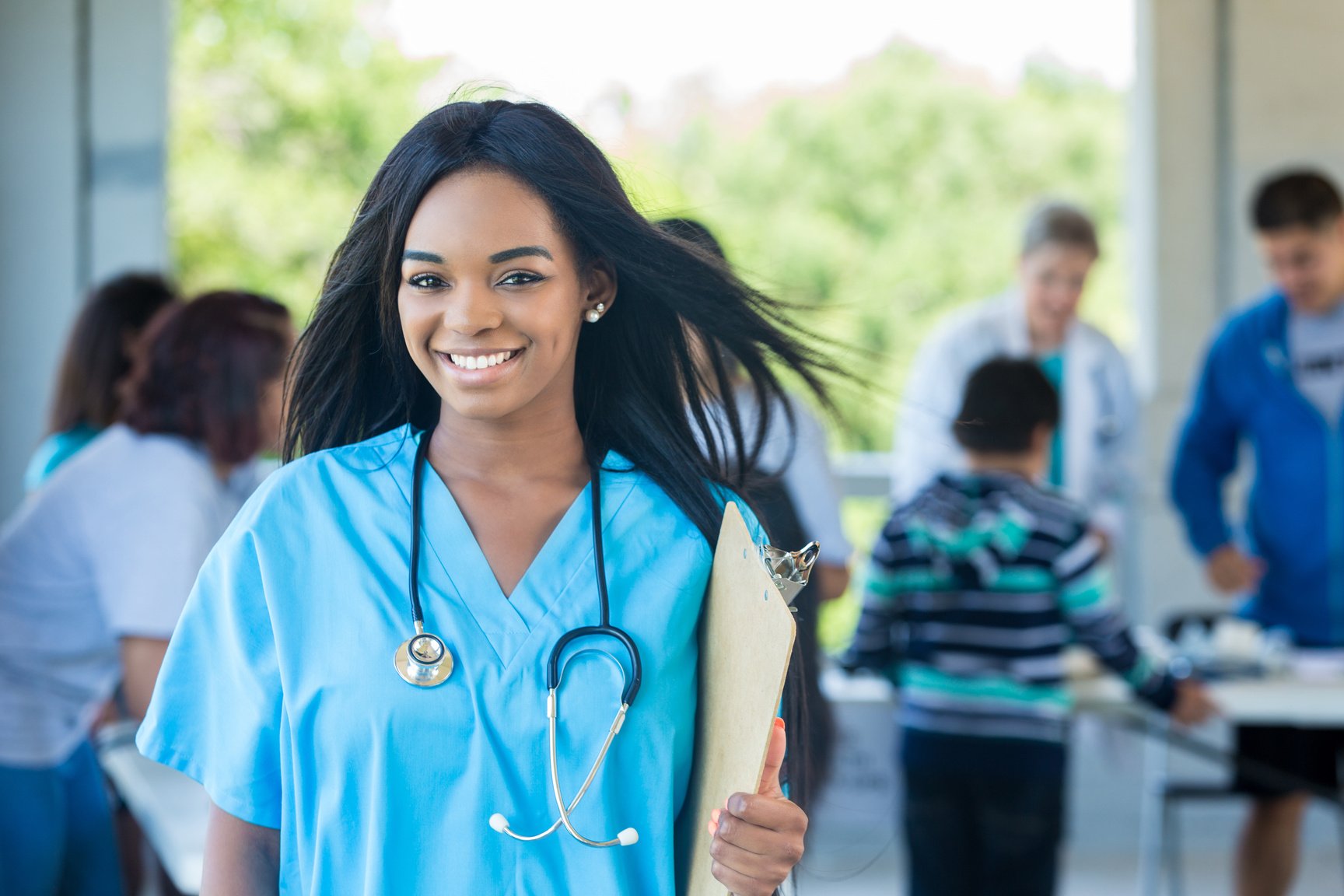 Cheerful healthcare professional volunteers during health fair